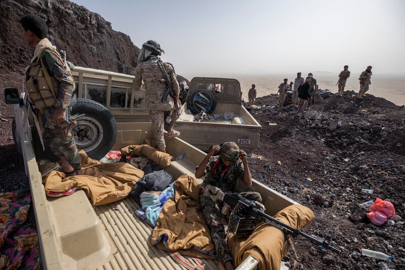 Yemeni fighters backed by the Saudi-led coalition patrol during clashes with Houthi rebels on the Kassara front line near Marib, Yemen. AP