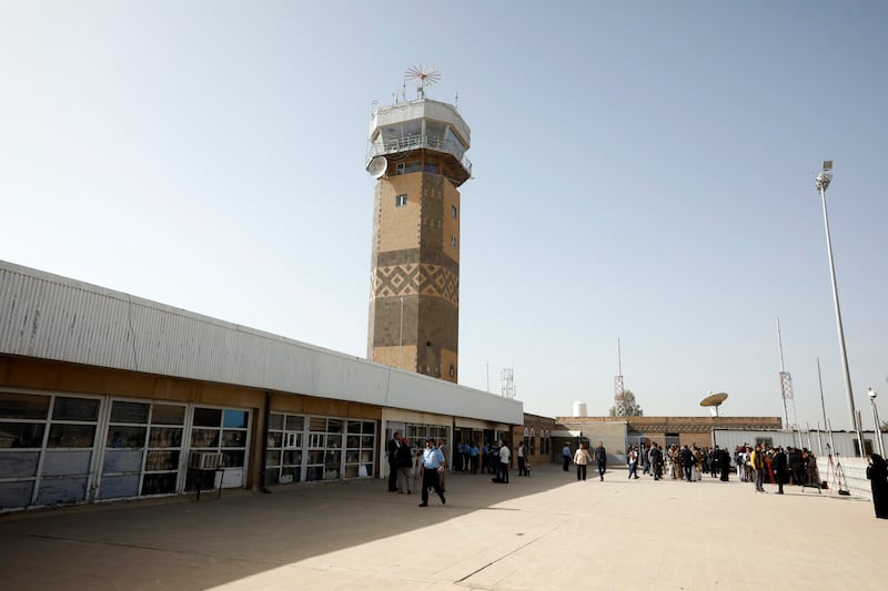 Staff pass the control tower of Sanaa International Airport after it was reopened for commercial flights. EPA