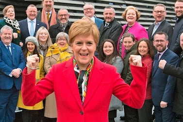Scottish National Party leader and Scotland's First Minister Nicola Sturgeon poses with SNP's newly-elected MPs after a successful campaign. AFP    