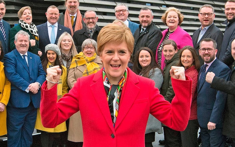 Scottish National Party (SNP) leader and Scotland's First Minister Nicola Sturgeon poses with SNP's newly elected MPs during a photo call outside the V & A Museum in Dundee, Scotland on December 14, 2019.  Prime Minister Boris Johnson called on Britons to put years of bitter divisions over the country's EU membership behind them as he vowed to use his resounding election victory to finally deliver Brexit next month. / AFP / NEIL HANNA
