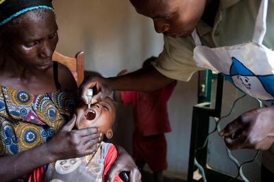 A ministry of health employee in DR Congo administers a polio vaccination. AFP