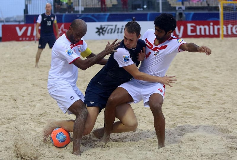UAE’s Ali Daryaei, right, clashes with Nicolas Perrera, centre, of the United States during their final Group A match in Tahiti. Gregory Boissy / AFP