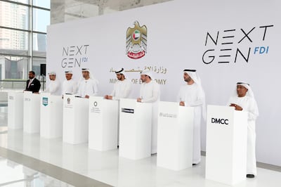 Dr Thani Al Zeyoudi, fourth from left, with executives from seven entities in Abu Dhabi and Dubai that entered into a partnership with the Ministry of Economy to convince digital companies to set up in the UAE. Pawan Singh / The National

