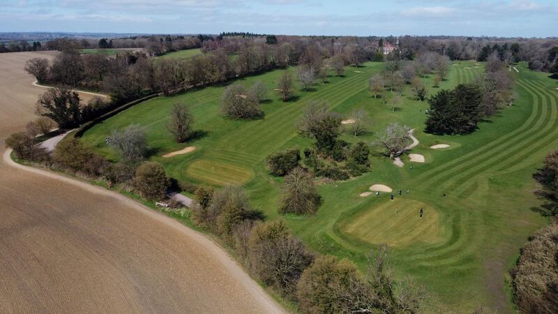 People play a round of golf at Batchwood in St Albans. Outdoor pools, tennis courts and golf courses will reopen just as warmer weather is forecast to hit England this week. Reuters