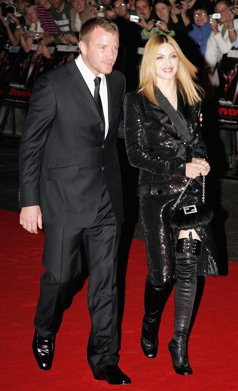 LONDON - SEPTEMBER 20:  Director, Guy Richie and wife singer Madonna arrive at the UK Premiere for "Revolver" at the Odeon Leicester Square on September 20, 2005 in London, England.  (Photo by Gareth Cattermole/Getty Images)