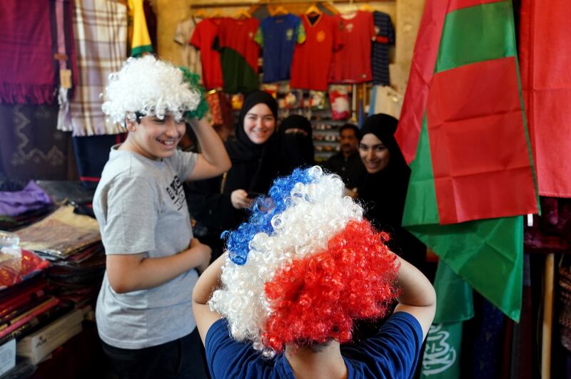 France fans in wigs at a shop in Souq Waqif. PA