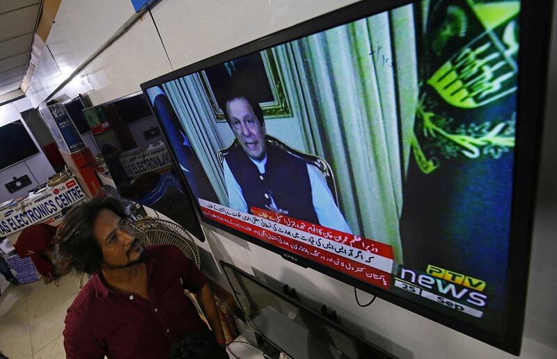 A man watches the televised speech of Pakistan's Prime Minister Imran Khan. EPA