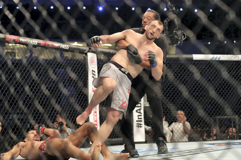 Abu Dhabi, United Arab Emirates - September 07, 2019: Welterweight bout between Nordine Taleb and Muslim Salikhov (grey shorts, winner) in the Early Prelims at UFC 242. Saturday the 7th of September 2019. Yas Island, Abu Dhabi. Chris Whiteoak / The National