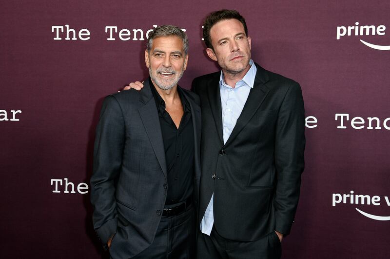 Wedding guest George Clooney and groom Ben Affleck arrive at a screening of The Tender Bar at the Directors Guild of America in Los Angeles.   Invision / AP