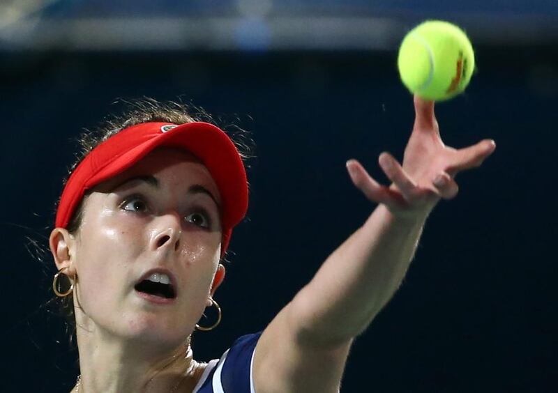 France's Alize Cornet serves the ball to Spain's Carla Suarez-Navarro during their quater-final match in the Dubai Duty Free Tennis Championship on February 20, 2014. AFP PHOTO / MARWAN NAAMANI

