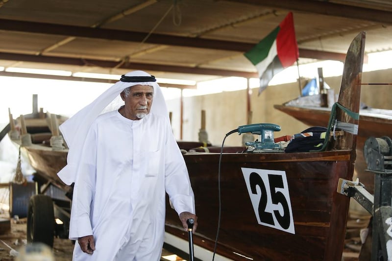 Emirati boat builder Ali Mattar Al Shamsi, 85, is photographed with one of his boats in his building yard in Ajman. Sarah Dea / The National