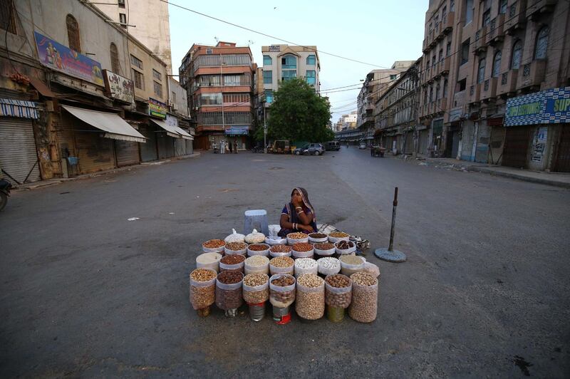 A Pakistani woman sells dry fruit on a road in Karachi, Pakistan.  EPA