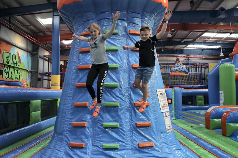 DUBAI , UNITED ARAB EMIRATES , January 15 ��� 2019 :- Left to Right -  Harriet Osgerby and Henry Osgerby playing at the Air Maniax, a brand new indoor adventure park of 23,000 sq ft, with activities for all ages opened in Al Quoz Industrial area in Dubai. (Pawan Singh / The National ) For Arts & Life. Story by Hala Khalaf