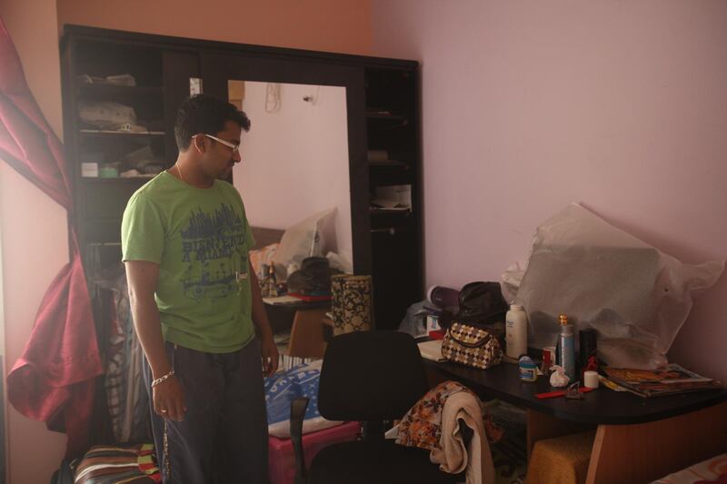 Dubai, UAE, July 8, 2012:
Vineesh Vasu, is seen here inside of his home. He has been living in this building for the past 32 years (which means, at 33, he spent one year living elsewhere).

The residents of the area were told on June 1st via text message that they would have to vacate their homes by mid july at the very latest. 

Lee Hoagland/The National