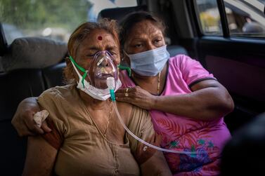 A Covid-19 patient receives oxygen inside a car provided by a Gurdwara, a Sikh house of worship, in New Delhi, India. AP Photo