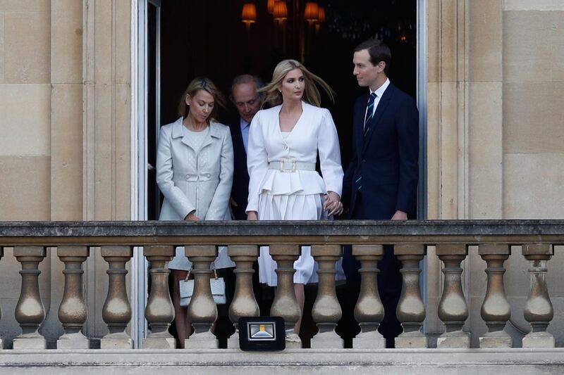 Ivanka Trump (2R) and her husband Senior Advisor to the President of the United States Jared Kushner (R) watch from a balcony at Buckingham Palace. AFP
