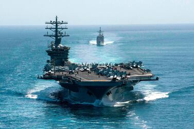 This handout photo courtesy of US Navy shows the aircraft carrier USS Nimitz (front) and the guided-missile cruiser USS Philippine Sea during a Strait of Hormuz transit on September 18, 2020. Iran's Foreign Minister Mohammad Javad Zarif on December 31, 2020, accused US President Donald Trump of aiming to fabricate a "pretext for war" as tensions mount between the two countries. His remarks come ahead of the first anniversary of the US killing of top Iranian military commander Qasem Soleimani in a drone strike in Baghdad on January 3. The Nimitz has been patrolling Gulf waters since late November 2020 and two US B-52 bombers recently overflew the region on December 30. - RESTRICTED TO EDITORIAL USE - MANDATORY CREDIT "AFP PHOTO / US NAVY / Petty Officer 3rd Class Elliot Schaudt" - NO MARKETING - NO ADVERTISING CAMPAIGNS - DISTRIBUTED AS A SERVICE TO CLIENTS / AFP / US NAVY / US NAVY / US NAVY / elliot Schaudt / RESTRICTED TO EDITORIAL USE - MANDATORY CREDIT "AFP PHOTO / US NAVY / Petty Officer 3rd Class Elliot Schaudt" - NO MARKETING - NO ADVERTISING CAMPAIGNS - DISTRIBUTED AS A SERVICE TO CLIENTS