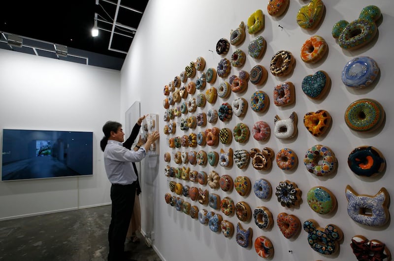 epa06617924 Exhibitors fix artwork 'Donut' bySouth Korean artist Kim Jae Yong during the 12th annual Art Dubai exhibition at Madinat Jumeirah, Dubai, United Arab Emirates, 21 March 2018.  EPA/ALI HAIDER