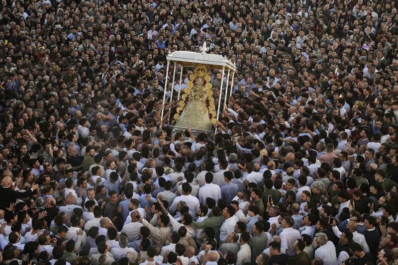 Pilgrims gather around an effigy of the Rocio Virgin during the annual pilgrimage near Huelva, in southern Spain. AFP