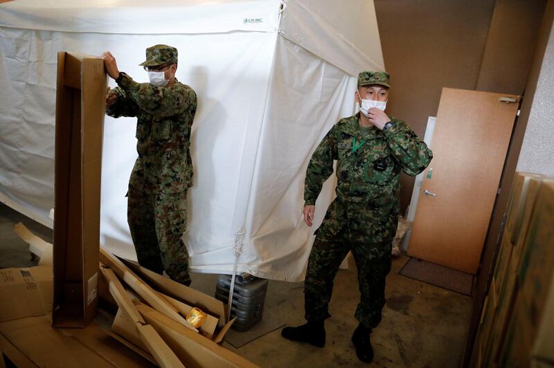 Japanese Self-Defence Forces soldiers work at a hotel that has been designated to accommodate asymptomatic people and those with light symptoms of the coronavirus disease to free up hospital beds, in Tokyo, Japan. Reuters