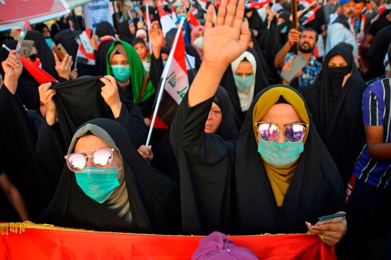 Iraqi women chant slogans and wave their country's national flag during during anti-government protests in the central Iraqi holy city of Najaf. AFP