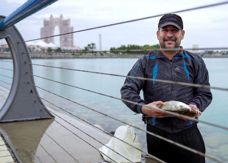 A fisherman with his catch in Abu Dhabi. Victor Besa / The National