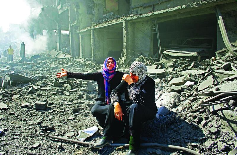 Palestinian women weep as they see their destroyed homes in the northern district of Beit Hanun in the Gaza Strip during an humanitarian truce on July 26, 2014. Photo by Heidi Levine for The National