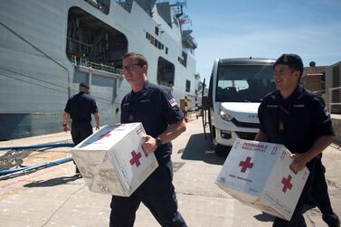 Members of the British Royal Navy carry medical supplies to a ship in Gibraltar as part of the UK’s foreign assistance programme. AFP