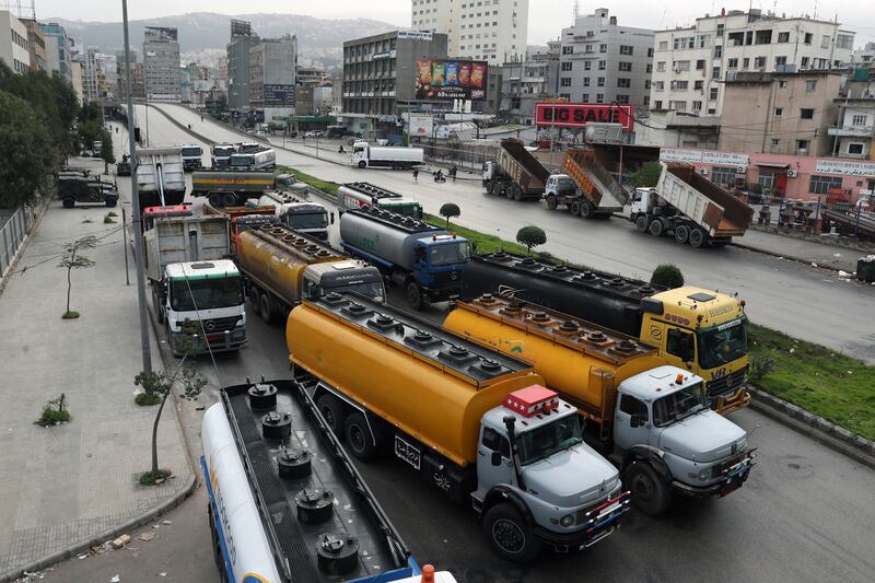 Lorry drivers block a main road with their vehicles during a general strike by public transport and workers' unions, protesting against the country's deteriorating economic and financial conditions, in Beirut, Lebanon. AP