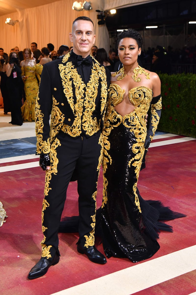 Actress, singer and dancer Ariana DeBose and fashion designer Jeremy Scott co-ordinate in black-and-gold Moschino designs. AFP