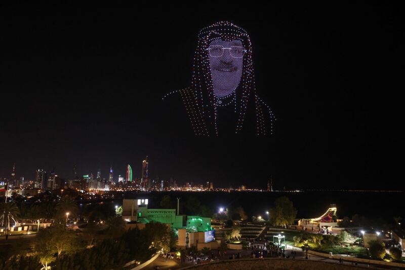 An image of Kuwait's Crown Prince Sheikh Mishal Al-Sabah hovers above Green Island during Independence day celebrations