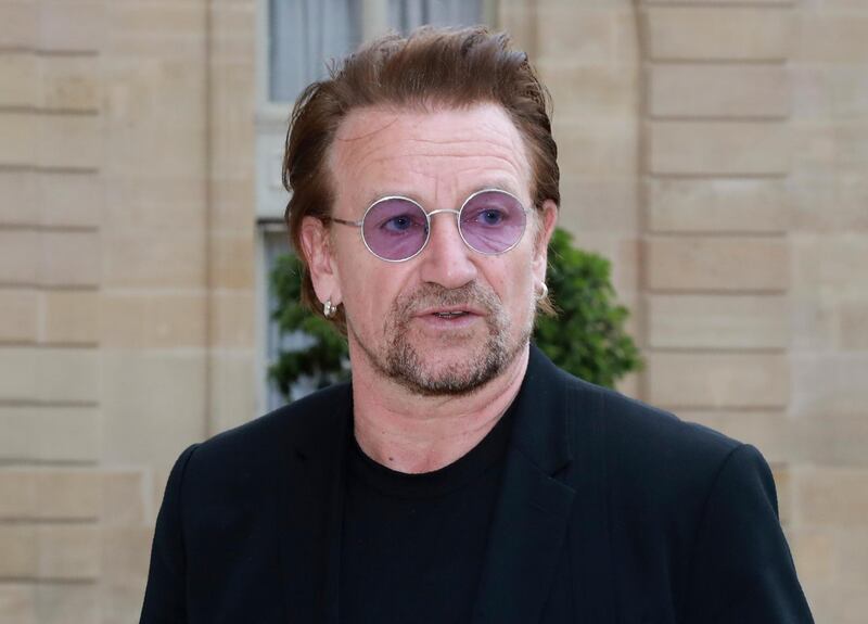 (FILES) This file photo taken on July 24, 2017 shows Irish U2 musician and philanthropist Bono, co-founder of the organisation ONE, as he leaves following his meeting with the French president at the Elysee Palace in Paris. 
U2 frontman Bono said on November 6, 2017, that he is "distressed" by leaked documents showing he invested in a Lithuanian shopping centre which may have broken tax rules, but welcomed reporting on the issue. The Irish singer owns a stake in a Maltese company that bought the mall via a Lithuanian holding company in 2007, according to the so-called Paradise Papers leaks reported by the BBC and the Guardian newspaper. / AFP PHOTO / JACQUES DEMARTHON