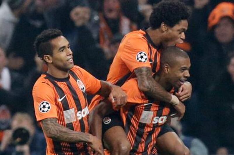 Alex Teixeira, Luiz Adriano and Fernandinho celebrate Shakhtar's goal against Chelsea in the Champions League.