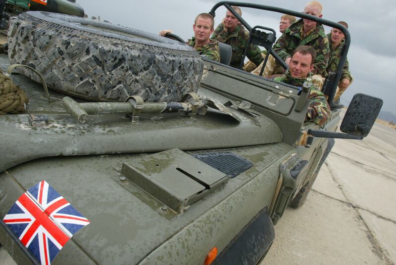 A Royal Marines commando unit in their Land Rover in 2002 on the tarmac at Bagram air base in Afghanistan