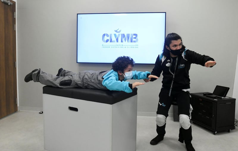 Abu Dhabi, United Arab Emirates - Instructor, Richard Manalaysay teaches Samih, 9, about indoor skydiving at CLYMB, Yas Island. Khushnum Bhandari for The National