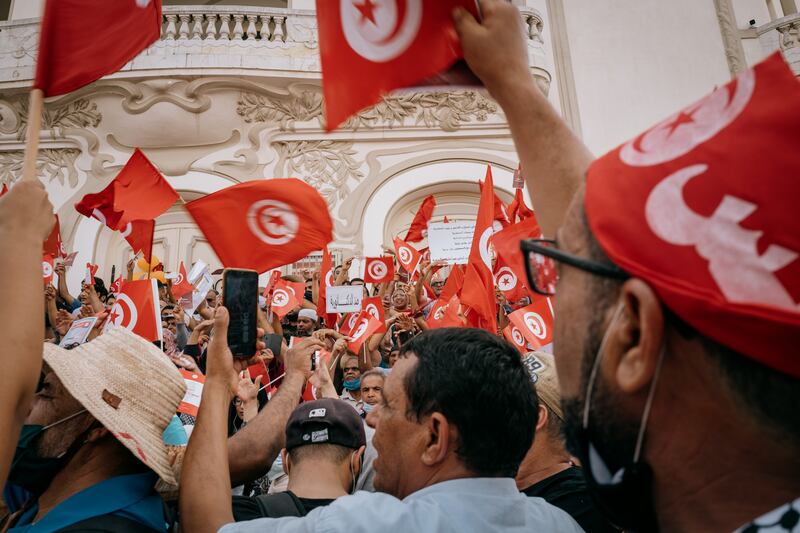 Large crowds on the steps of the national theatre.