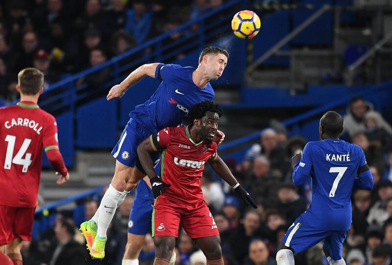 Chelsea defender Gary Cahill leaps for a header over Swansea's Wilfried Bony. Andy Rain / EPA