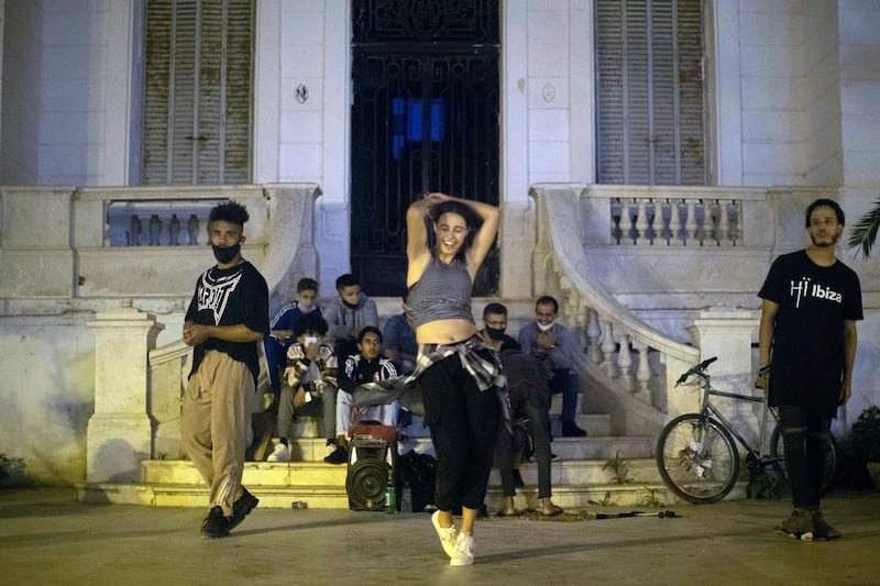 A street dancer performs along with her band in Rabat, Morocco. AP Photo