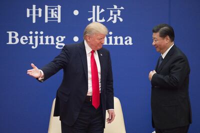 (FILES) In this file photo US President Donald Trump (L) gestures next to China's President Xi Jinping during a business leaders event at the Great Hall of the People in Beijing on November 9, 2017. Donald Trump pleaded with China's leader Xi Jinping for help to win re-election in 2020, the US president's former aide John Bolton writes in an explosive new book, according to excerpts published June 17. / AFP / Nicolas ASFOURI / TO GO WITH AFP STORY by AFP bureaux, with Herve Rouach, "Trump, Syria and Facebook: the volatile cocktail of the 2010s"
