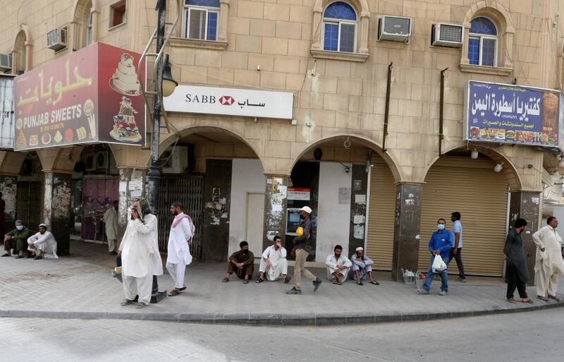 Foreign workers sit on the street after losing their jobs in Riyadh, Saudi Arabia. Reuters