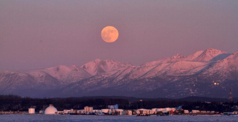 The moon rises over the Chugach Mountains in Anchorage, Alaska. Dan Joling / AP Photo.
