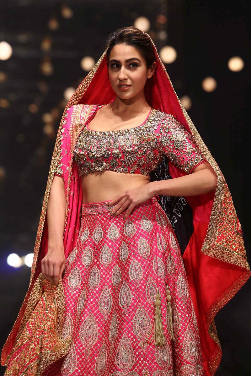 Sara Ali Khan presents a creation of designers Abu Jani and Sandeep Khosla during the Delhi chapter of the Blenders Pride Fashion Tour 2019-20 in New Delhi. AFP