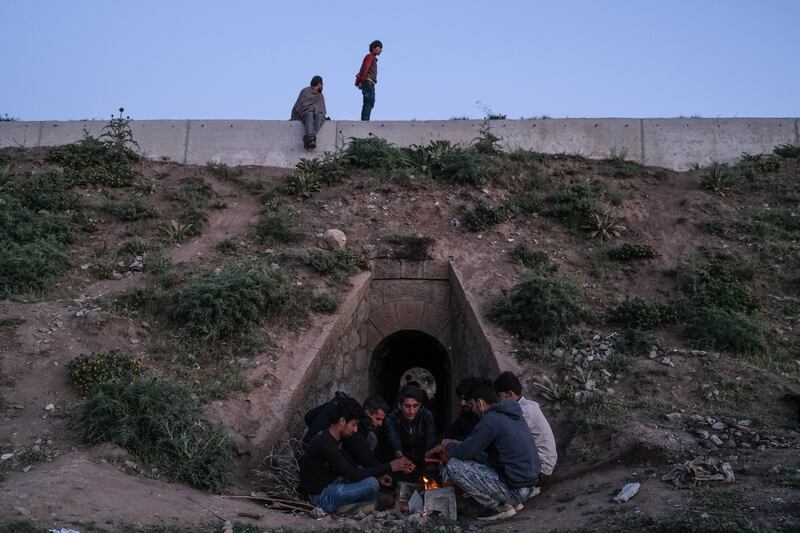 A group of Afghan and Iranian refugees rest at a fire next to the railway in Tatvan district in Bitlis city eastern province of Turkey.