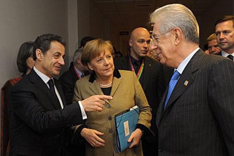 France's President Nicolas Sarkozy, Germany's Chancellor Angela Merkel and Italy's Prime Minister Mario Monti relax together prior to a meeting at the European Council in Brussels ahead of the European Union leaders summit yesterday, but there was little cheer at the meeting proper.