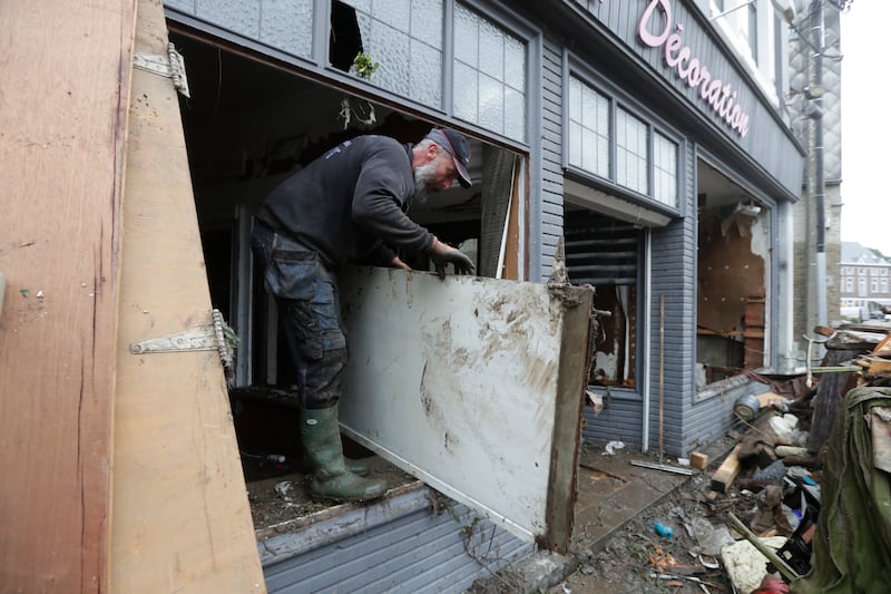 Residents clean up after heavy rains caused severe flooding in Ensival, Verviers, Belgium.