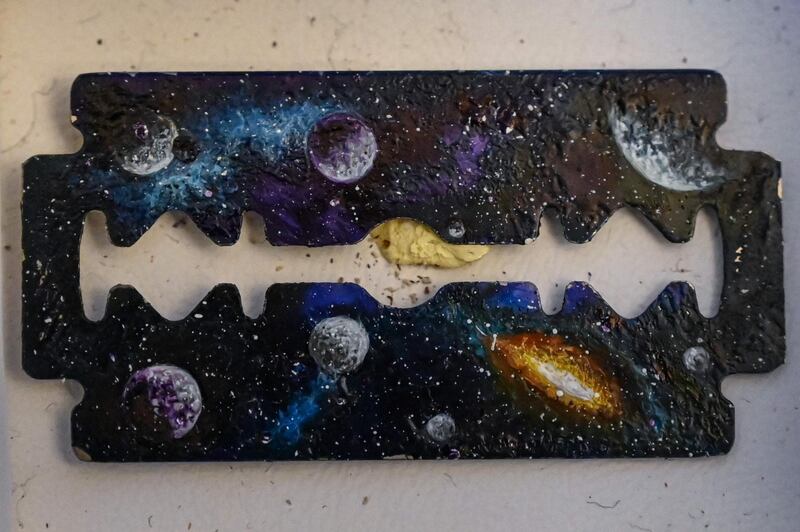 A landscape painted on a razor blade by Turkey's micro artist Hasan Kale in Istanbul.