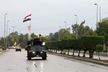 Iraqi security forces patrol a street, during a curfew imposed to prevent the spread of coronavirus disease in Baghdad. Reuters