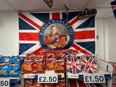 A coronation-themed flag above bags of crisps in a supermarket in central London before the coronation. AFP