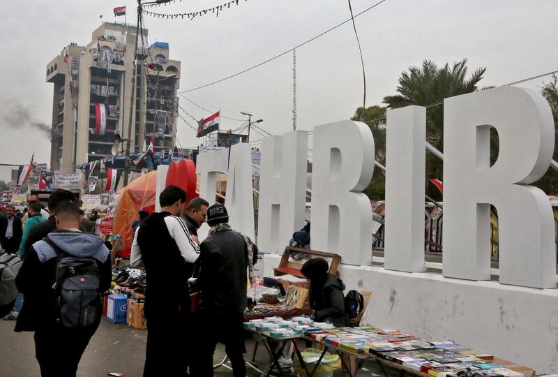 Iraqi protesters gather at Tahrir square in the capital Baghdad on December 16, 2019 during ongoing anti-government demonstrations. A supporter of Iraqi anti-government demonstrators was gunned down in Baghdad, a police source said yesterday, the fourth backer of the protest movement to be killed in two weeks. Mohammed al-Doujaili, 24, was shot in the back near the Tahrir Square protest hub on Saturday night, the police source said. Another man who was with him was wounded in the same attack, and al-Doujaili died of his wounds at a Baghdad hospital Sunday morning, relatives said.
 / AFP / SABAH ARAR
