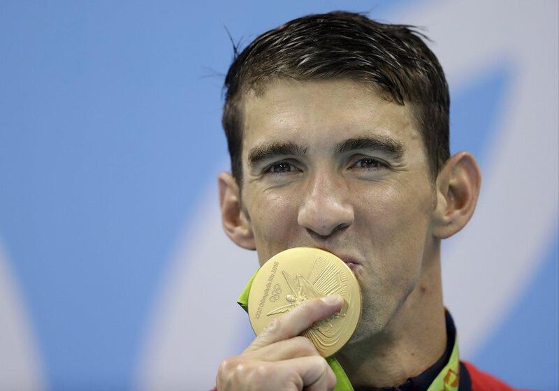 United States' Michael Phelps kisses his gold medal after the men's 4x100-meter freestyle final during the swimming competitions at the 2016 Summer Olympics, Monday, Aug. 8, 2016, in Rio de Janeiro, Brazil. (AP)